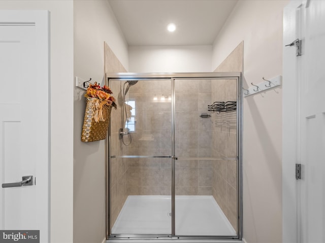 bathroom featuring a shower with door