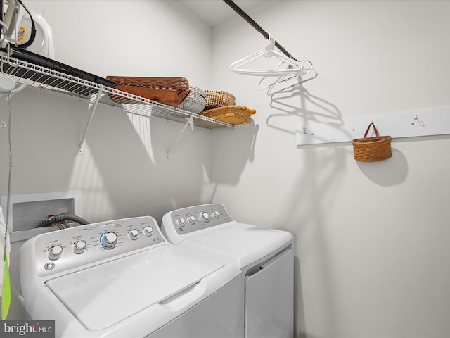 clothes washing area with separate washer and dryer