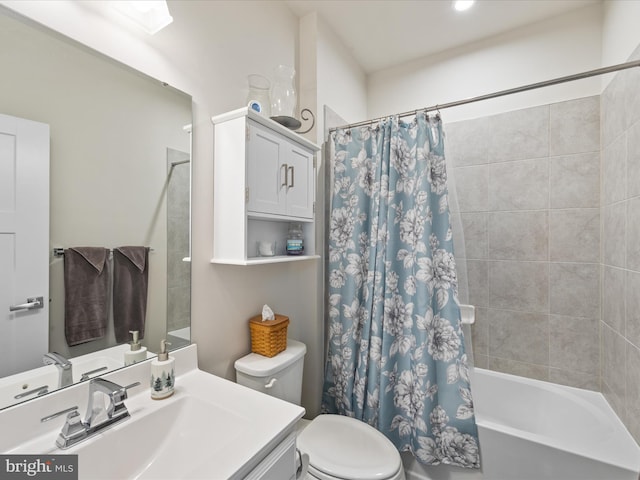 full bathroom featuring shower / tub combo with curtain, vanity, and toilet