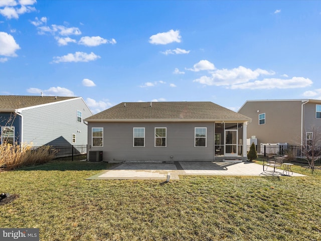 back of house featuring a lawn, a sunroom, cooling unit, and a patio area