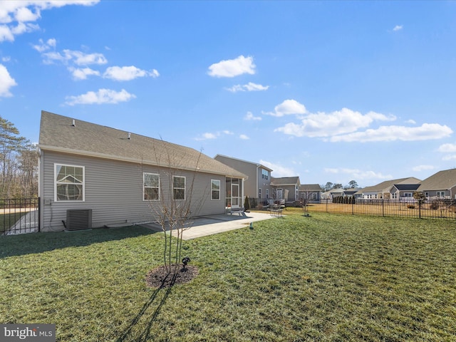 rear view of house featuring central AC, a patio area, and a lawn