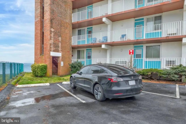 view of building exterior featuring uncovered parking