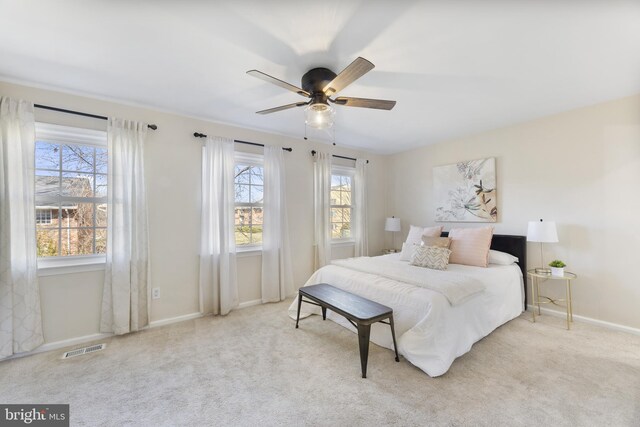 bedroom with visible vents, baseboards, a ceiling fan, and carpet flooring