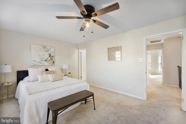 bedroom featuring visible vents, light colored carpet, a ceiling fan, and baseboards