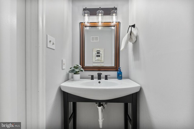 bathroom featuring visible vents and a sink