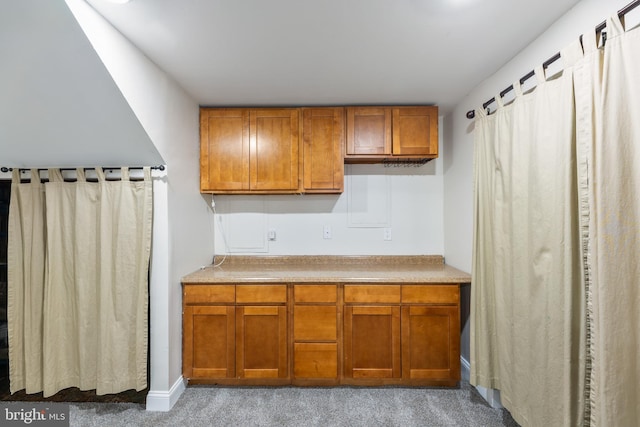 kitchen featuring light countertops and brown cabinets