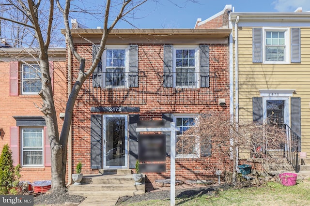 multi unit property featuring entry steps and brick siding