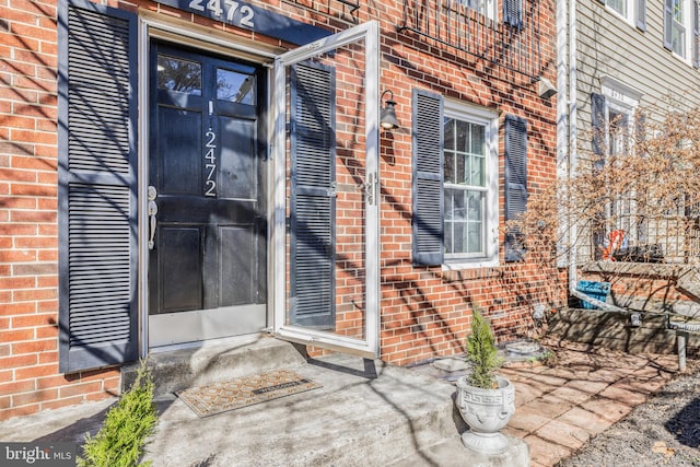 property entrance with brick siding