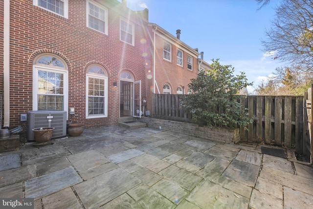 view of patio / terrace with cooling unit and fence