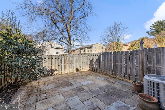 view of patio with cooling unit and a fenced backyard