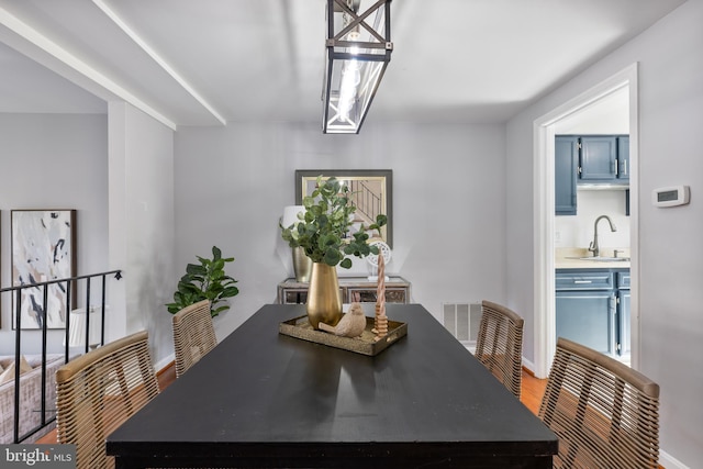 dining room featuring visible vents and wood finished floors