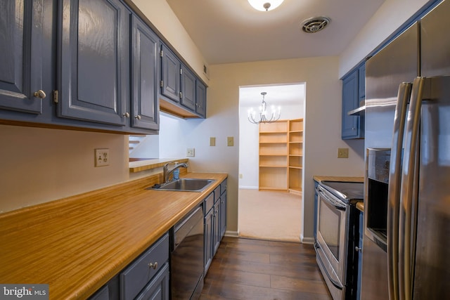 kitchen with sink, a notable chandelier, pendant lighting, dark hardwood / wood-style floors, and stainless steel appliances