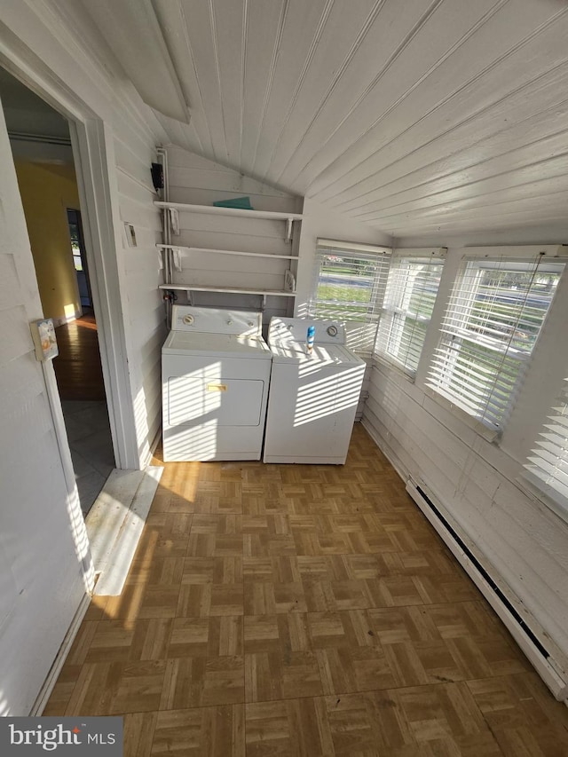 laundry area featuring washer and dryer, a baseboard radiator, wood ceiling, and dark parquet floors