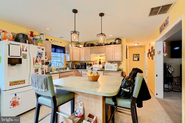 kitchen featuring light countertops, visible vents, light brown cabinetry, a sink, and white appliances