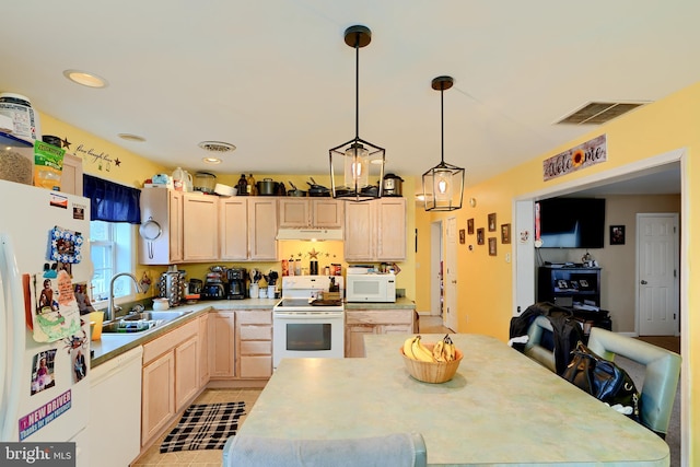 kitchen with light countertops, white appliances, a sink, and visible vents