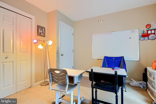 carpeted home office featuring baseboards