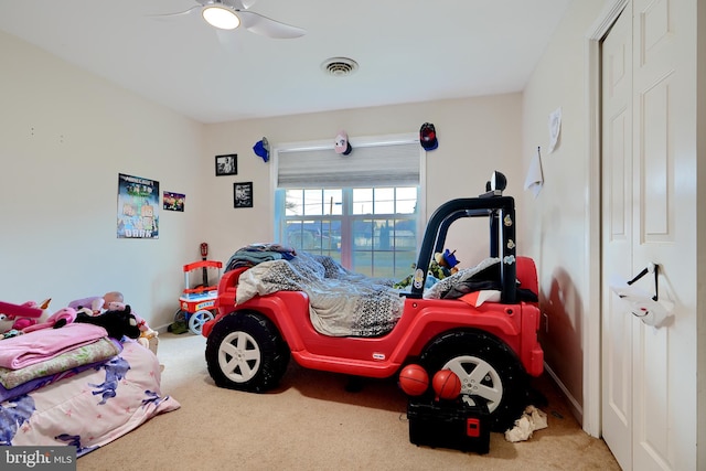 carpeted bedroom featuring ceiling fan and visible vents