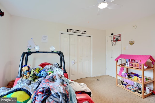 bedroom featuring a closet, a ceiling fan, and light colored carpet