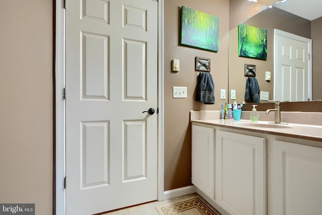 bathroom with baseboards and vanity