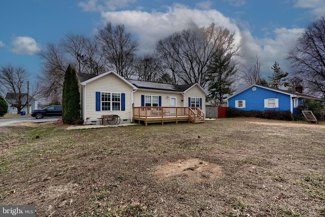 view of front of house with a front yard, crawl space, and a deck