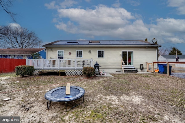 back of property featuring entry steps and a deck