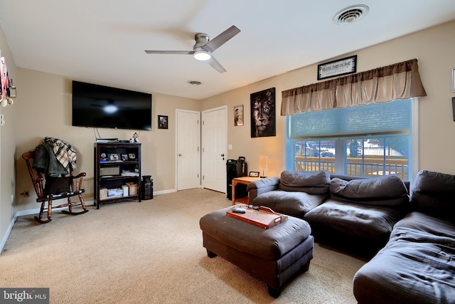 living room with ceiling fan, carpet flooring, visible vents, and baseboards