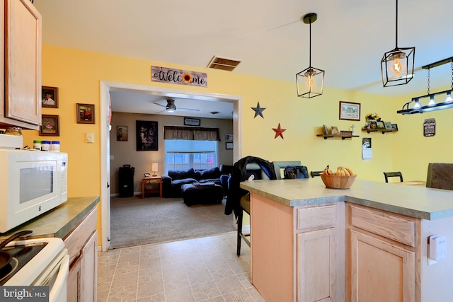 kitchen with open floor plan, light countertops, white appliances, and light brown cabinetry