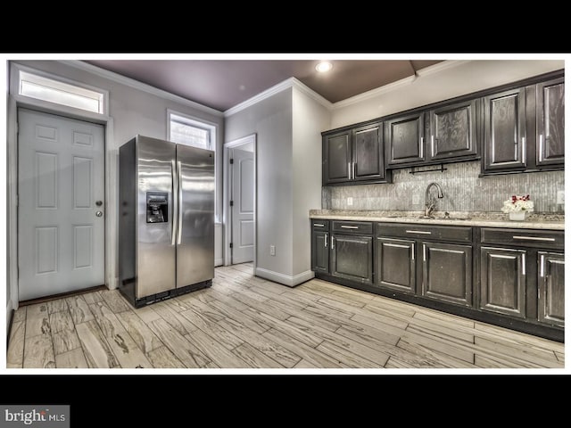 kitchen with light hardwood / wood-style flooring, sink, stainless steel refrigerator with ice dispenser, crown molding, and decorative backsplash