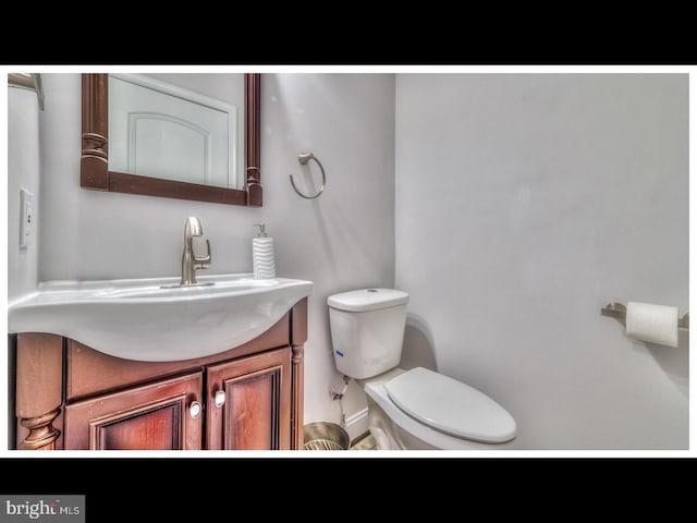 bathroom with toilet and vanity