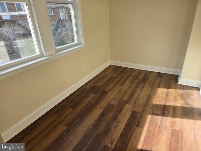 spare room featuring dark hardwood / wood-style floors