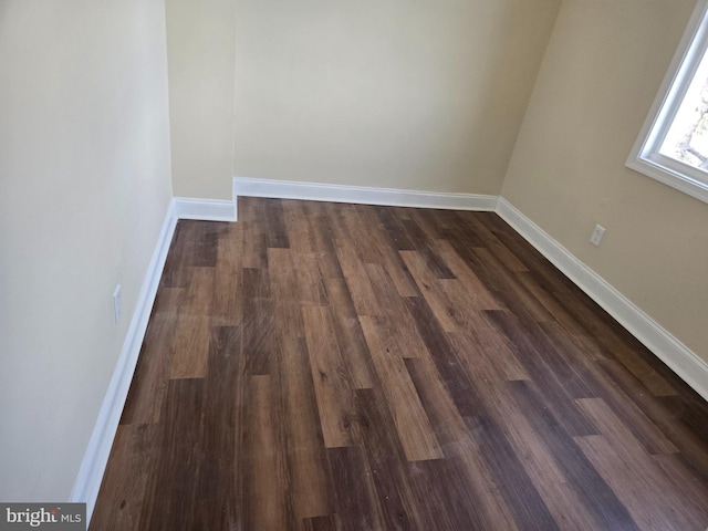 empty room with dark hardwood / wood-style floors