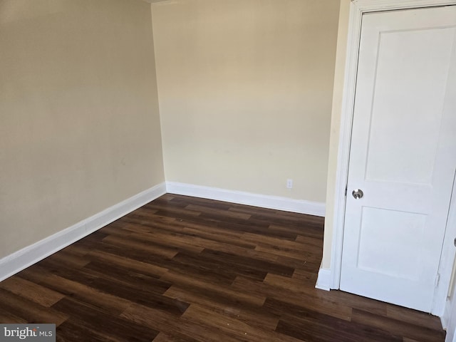 empty room featuring dark wood-type flooring