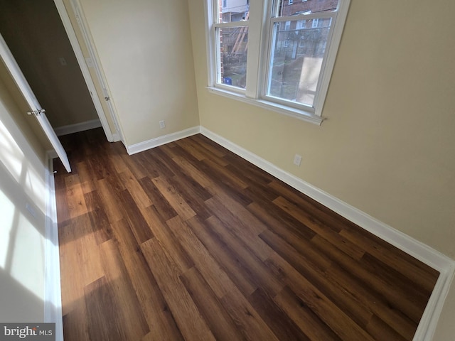 unfurnished bedroom with dark hardwood / wood-style floors