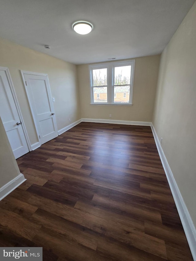 spare room featuring dark hardwood / wood-style flooring