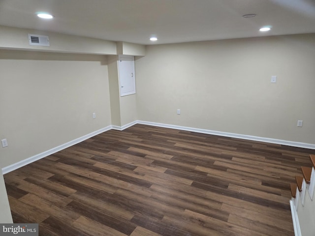 basement with dark hardwood / wood-style floors