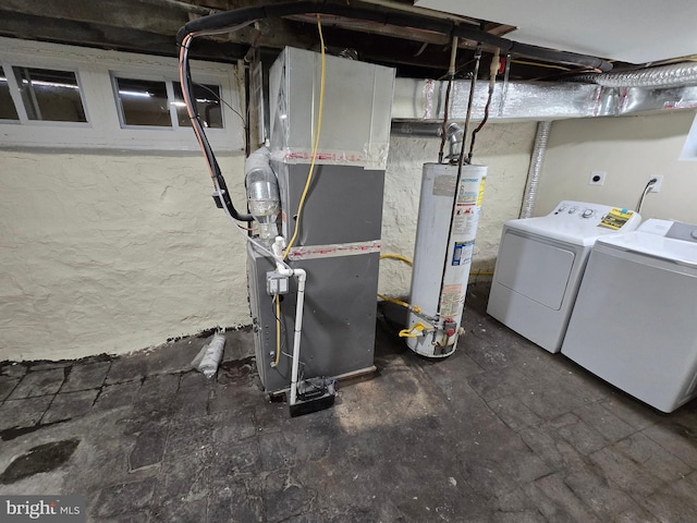 basement with water heater, washer and dryer, and heating unit