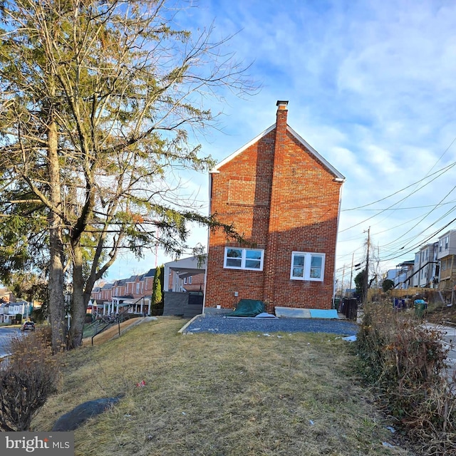 back of house with a lawn