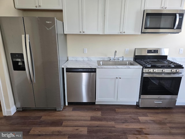 kitchen with white cabinetry, stainless steel appliances, and dark hardwood / wood-style floors