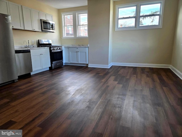 kitchen featuring white cabinetry, sink, dark hardwood / wood-style floors, and appliances with stainless steel finishes