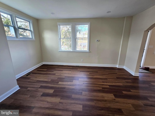 unfurnished room with dark hardwood / wood-style floors