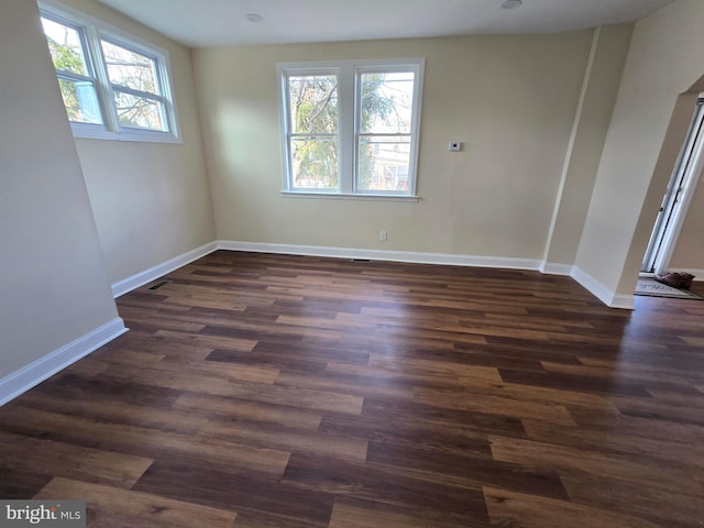 unfurnished room with dark hardwood / wood-style floors