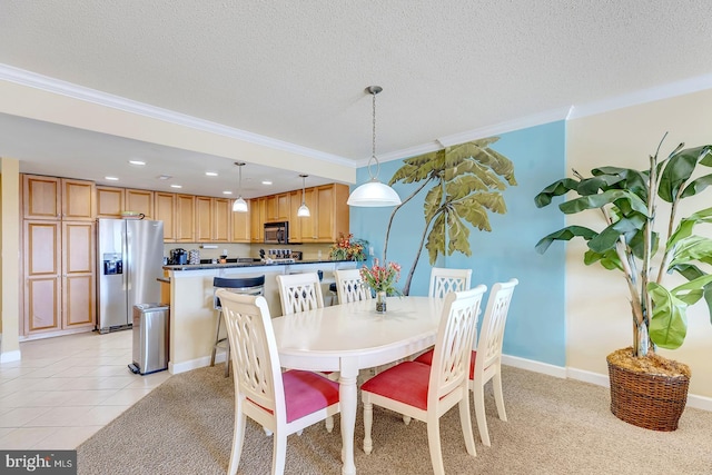 dining space featuring light tile patterned floors, ornamental molding, and a textured ceiling