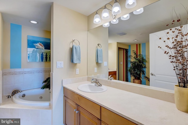 full bath featuring visible vents, a tub with jets, and vanity