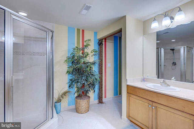 full bath with a stall shower, visible vents, vanity, and baseboards