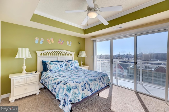 bedroom featuring visible vents, access to outside, a tray ceiling, a textured ceiling, and crown molding