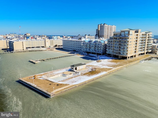 birds eye view of property with a water view and a city view