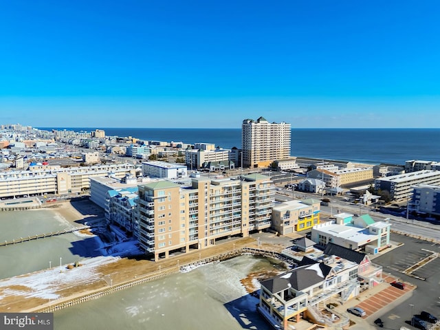 birds eye view of property featuring a water view, a view of city, and a view of the beach