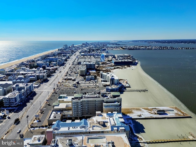 drone / aerial view featuring a beach view, a water view, and a city view