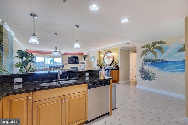 kitchen featuring a sink, open floor plan, dishwasher, dark stone countertops, and pendant lighting