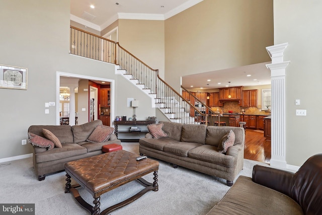 living area with baseboards, stairway, crown molding, ornate columns, and recessed lighting